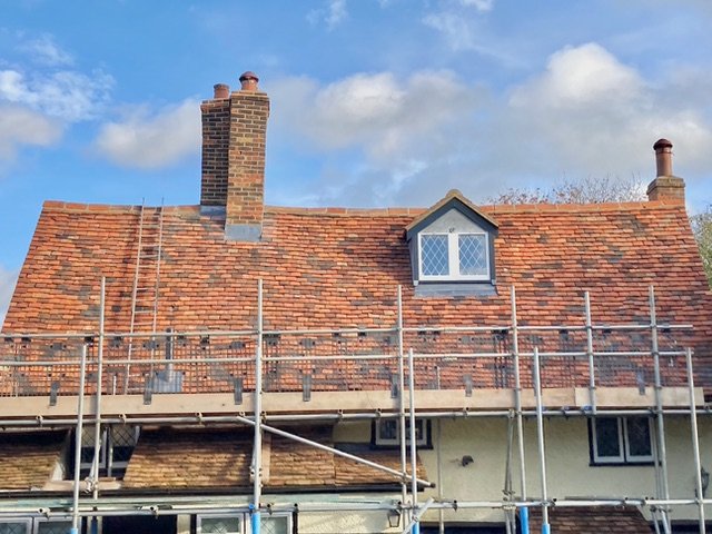 Roofing work in progress with scaffolding