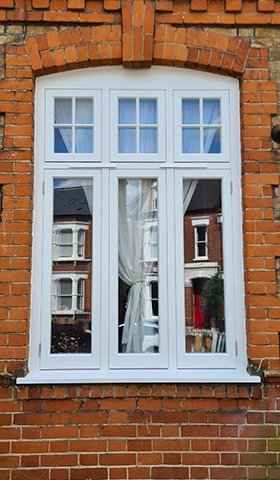 Close-up of a newly installed sash window in a brick wall.