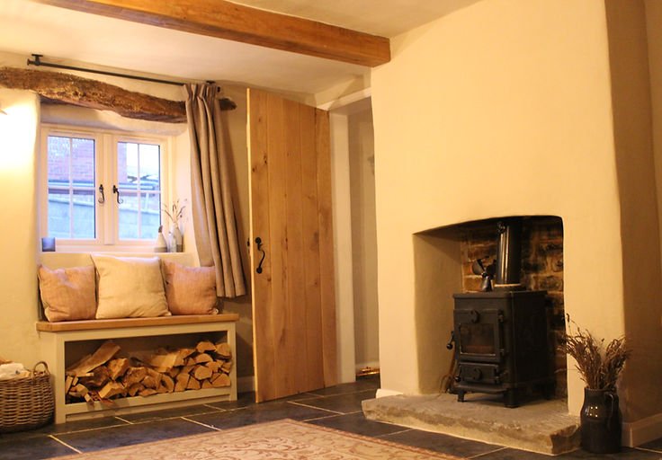 Finished room with plastered walls and fireplace, showcasing the final result of their work.