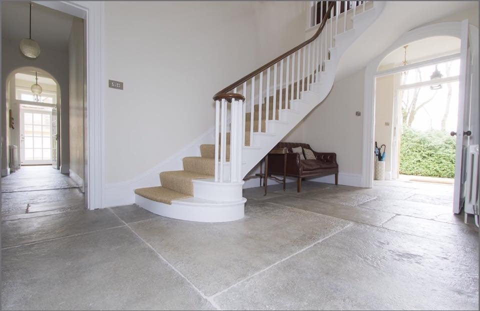 Restored flagstone flooring in a period home entryway.