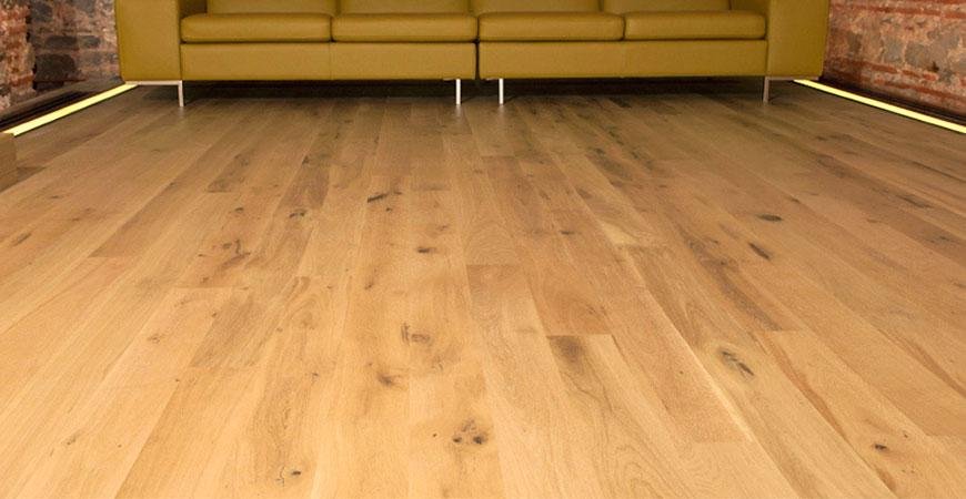 Light wood flooring in a modern setting with a yellow couch.