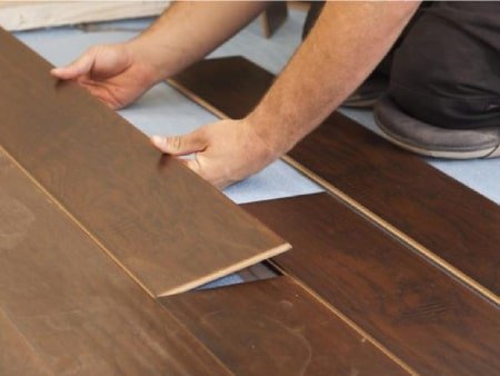 Close-up of wood floor installation in progress.