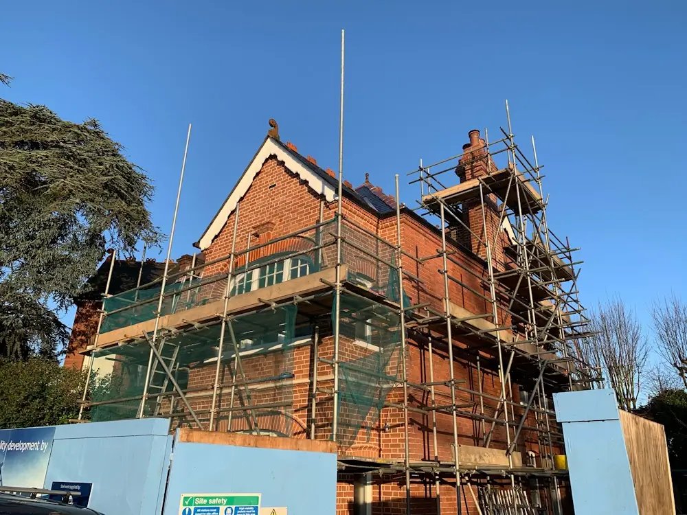 Period home undergoing restoration with scaffolding.