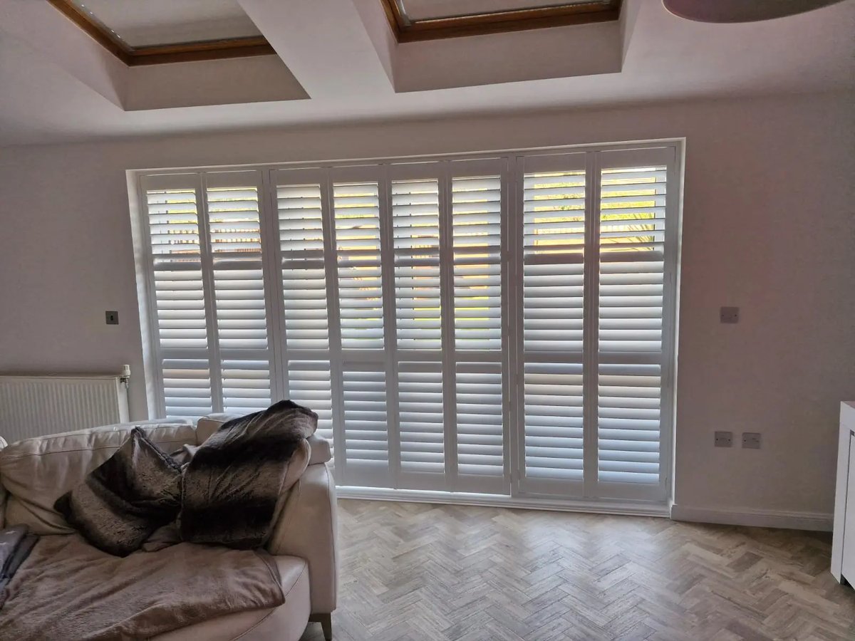 Living room with tall window shutters