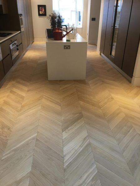 Finished herringbone wood floor in kitchen