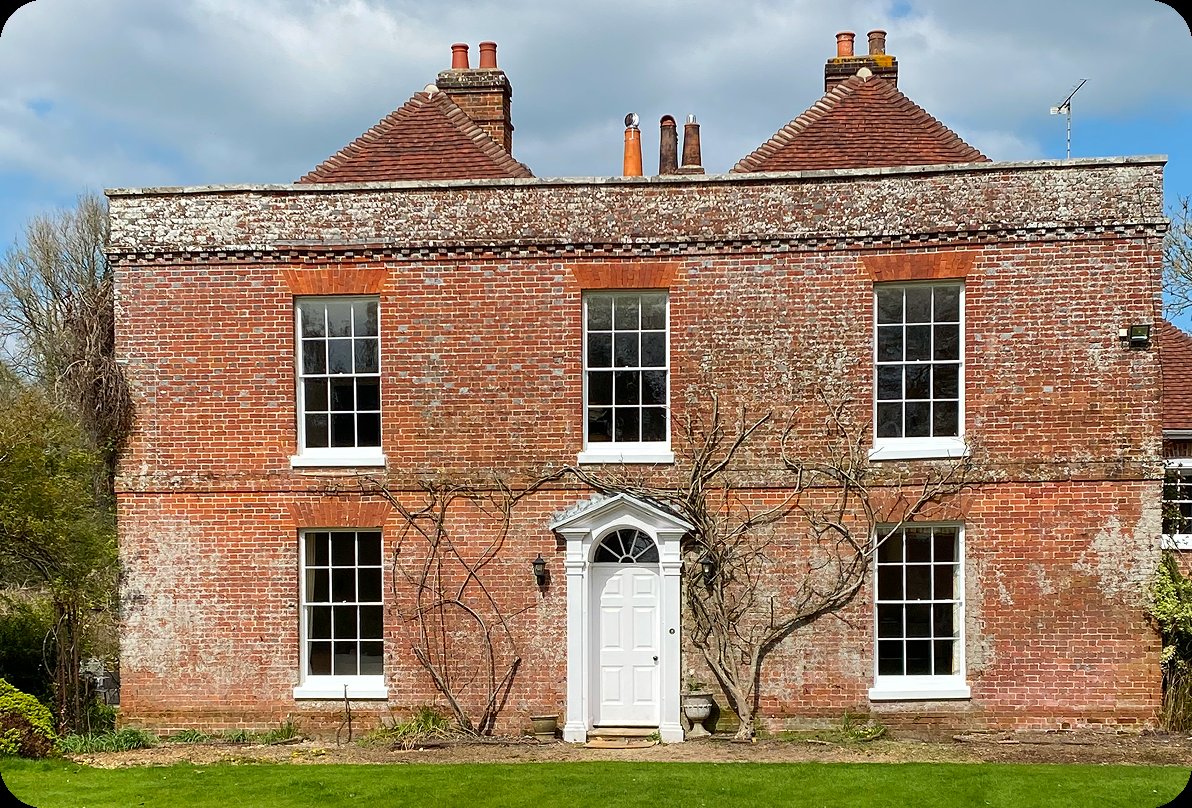 Full view of a period home with sash windows, showcasing the potential restoration work.