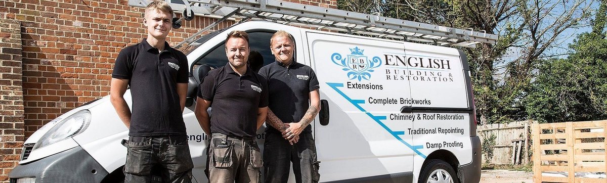 Team photo with company van, showing their branding and services.
