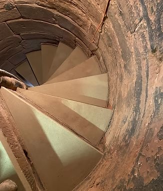Stone spiral staircase, showcasing stonemasonry work.