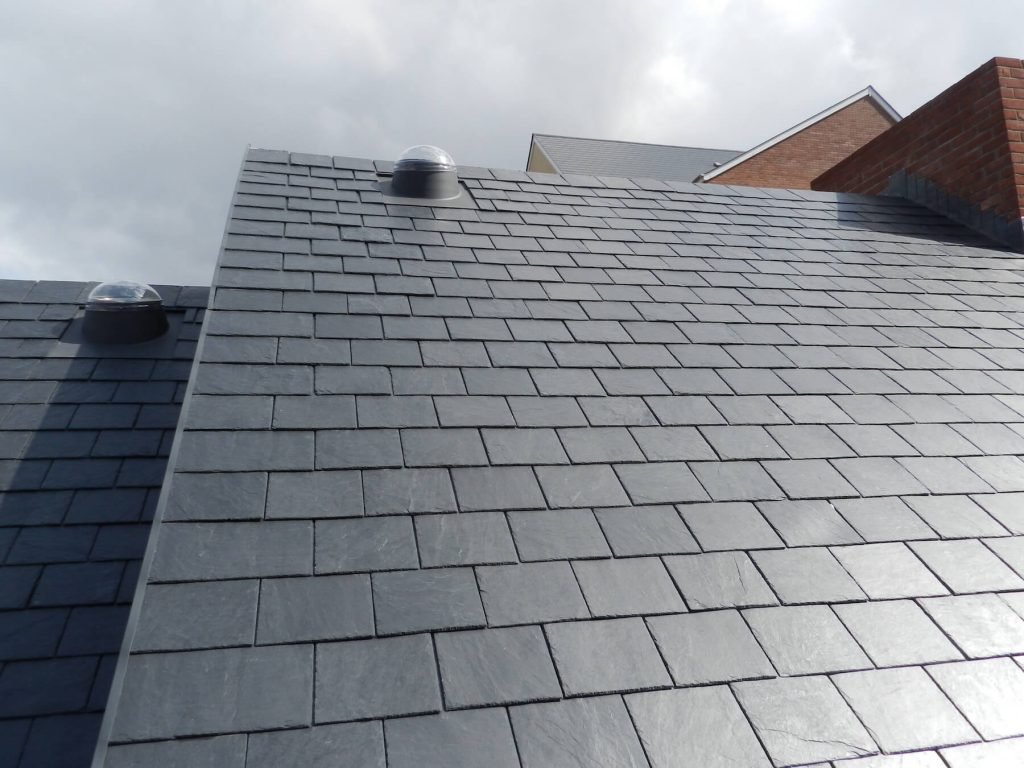 Slate roof with skylights, demonstrating roofing expertise.
