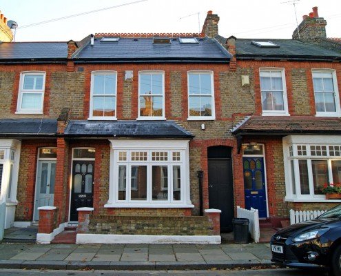Terraced houses with visible sash windows, potentially showcasing before/after.
