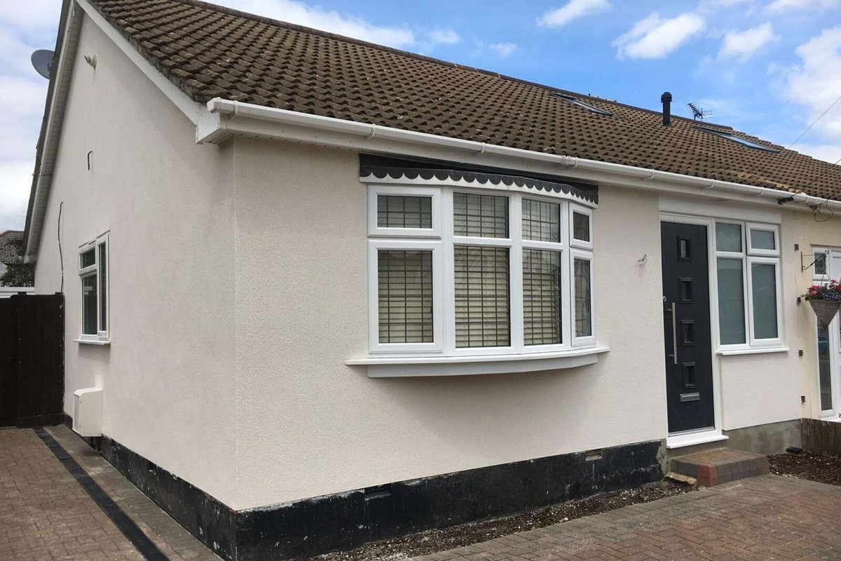 Exterior of a house with fresh plastering and paintwork.