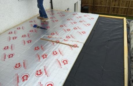 Insulation being installed on a flat roof.