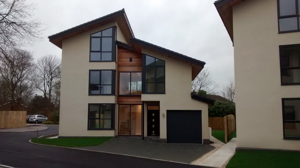 Completed modern house with timber accents, demonstrating the final product.