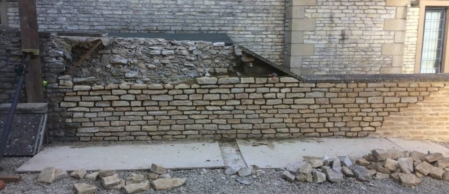 Stone wall under construction or repair, showing the process.