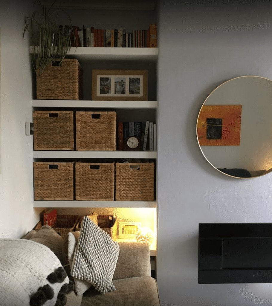 Built-in shelving unit with baskets and decor.