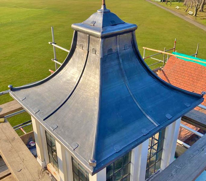 Close-up of a newly installed metal roof on a small structure