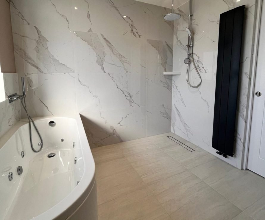 Bathroom renovation with modern fixtures and tiling.