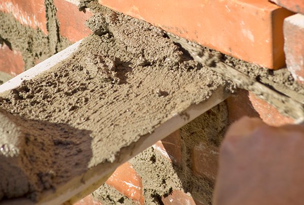 Close-up of lime pointing process, showing the application of mortar.