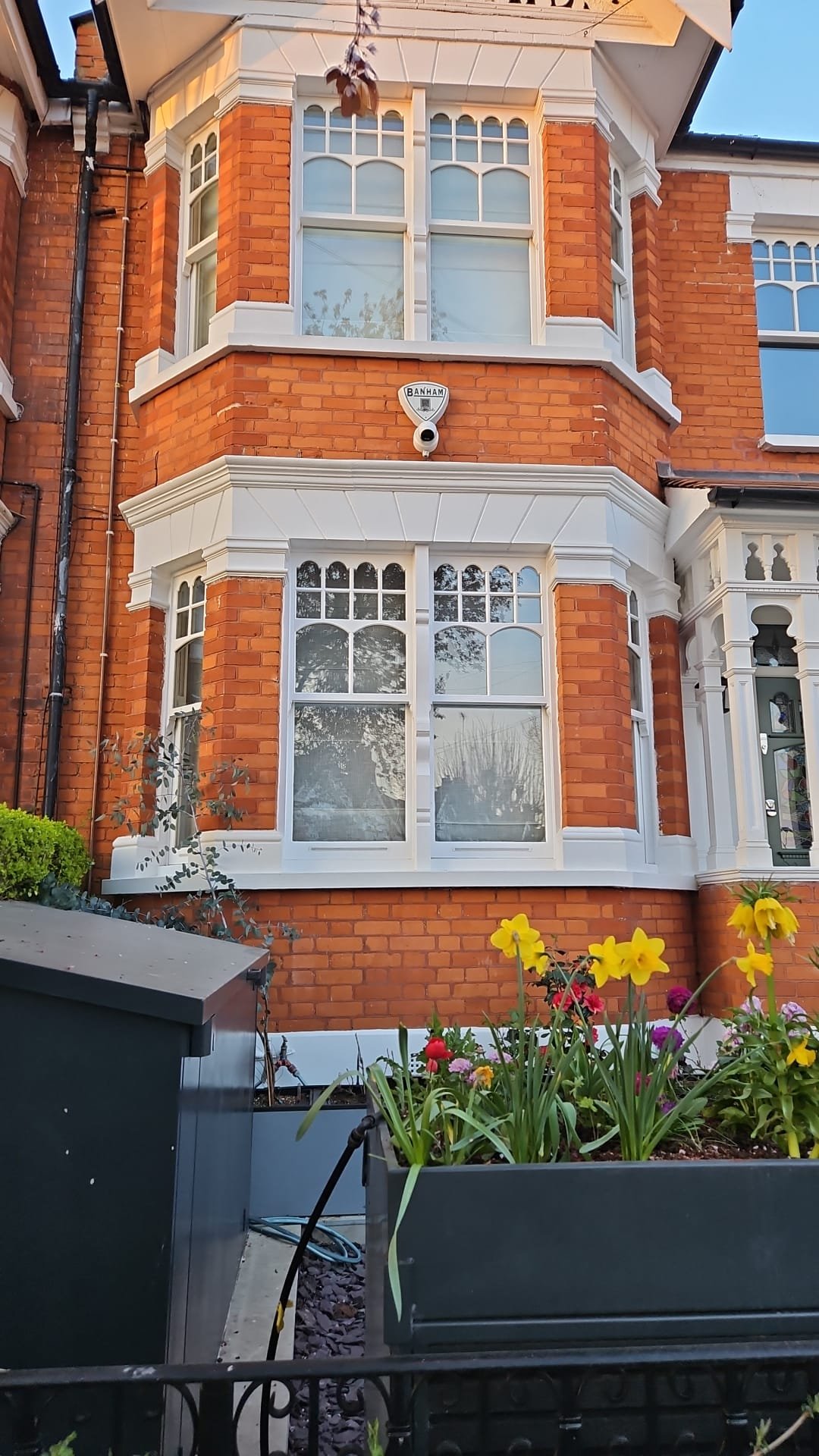 Close-up of a period home with restored sash windows and decorative details.