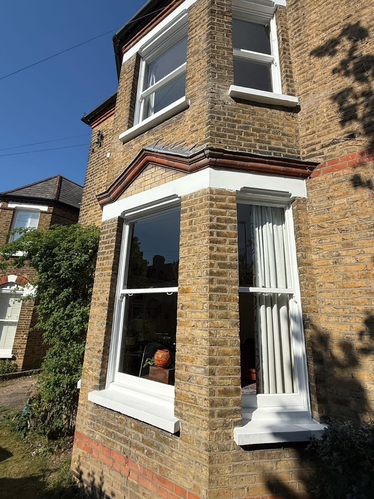 Exterior shot of a period home with restored sash windows.
