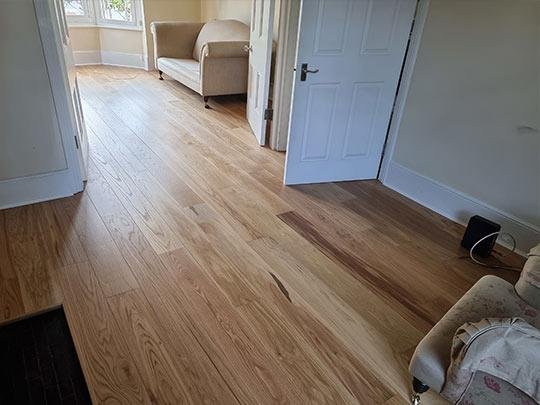 Wide shot of wood flooring in a living room, demonstrating the overall look and feel.