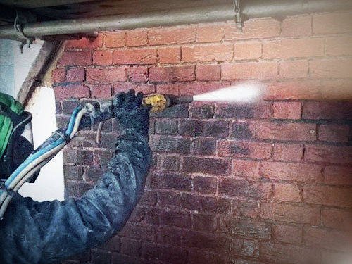 Brick cleaning process using a pressure washer.