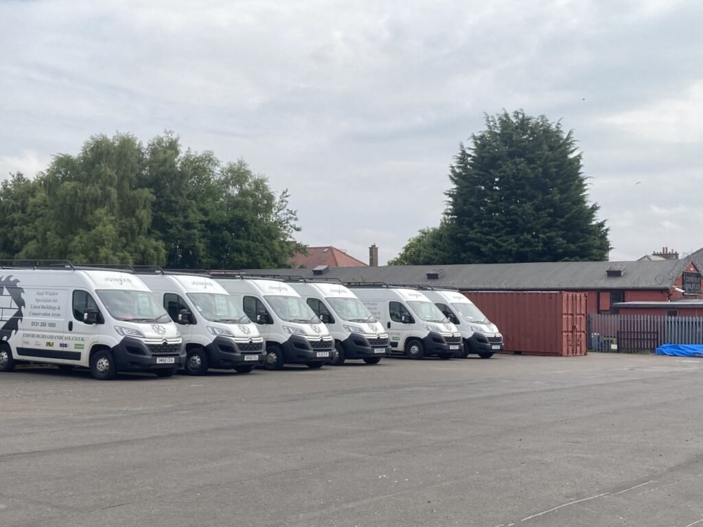 Fleet of company vans, showing scale and professionalism.
