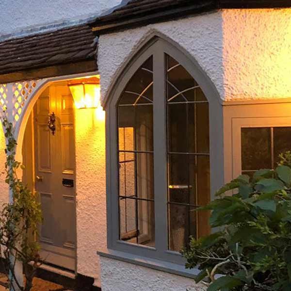 Exterior shot of a period home with a newly fitted arched window and door.