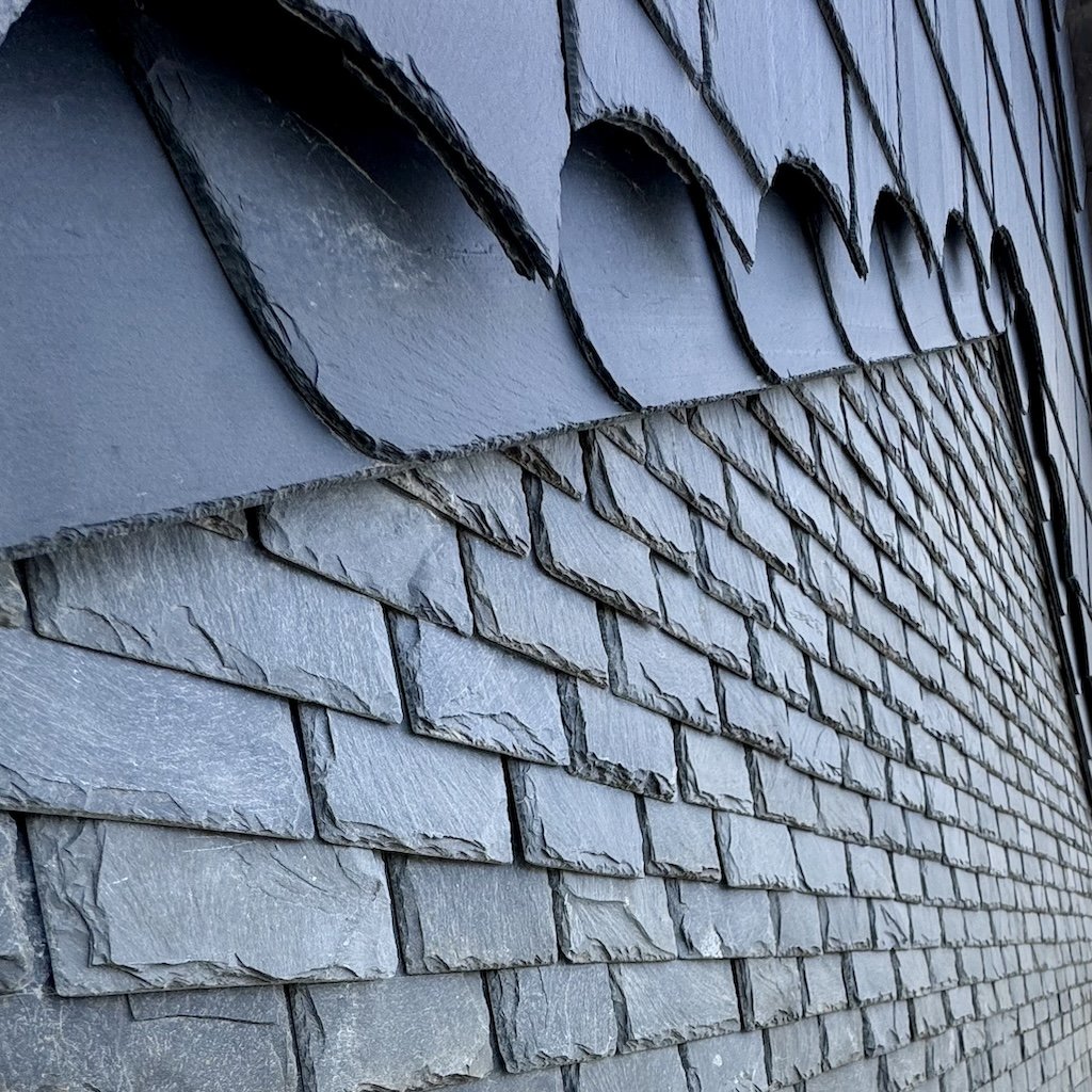 Close-up of a slate roof showing different patterns.