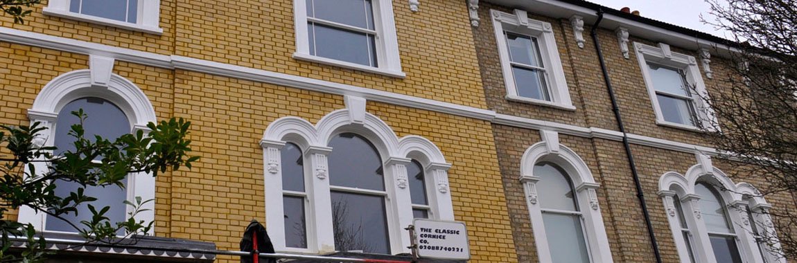 Exterior of period homes showcasing cornice and window detailing.