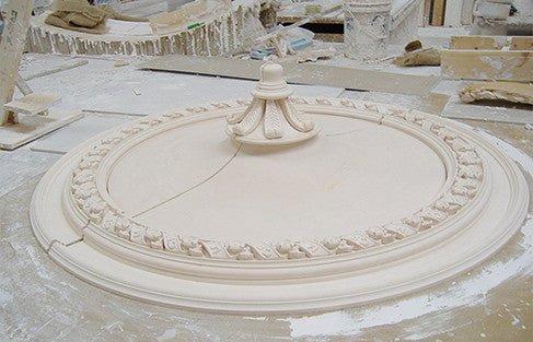 Plaster ceiling rose in workshop setting.