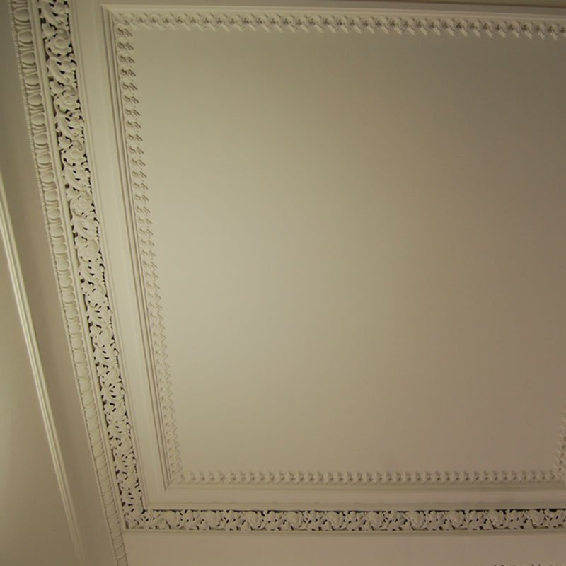 Finished plaster ceiling rose with chandelier.