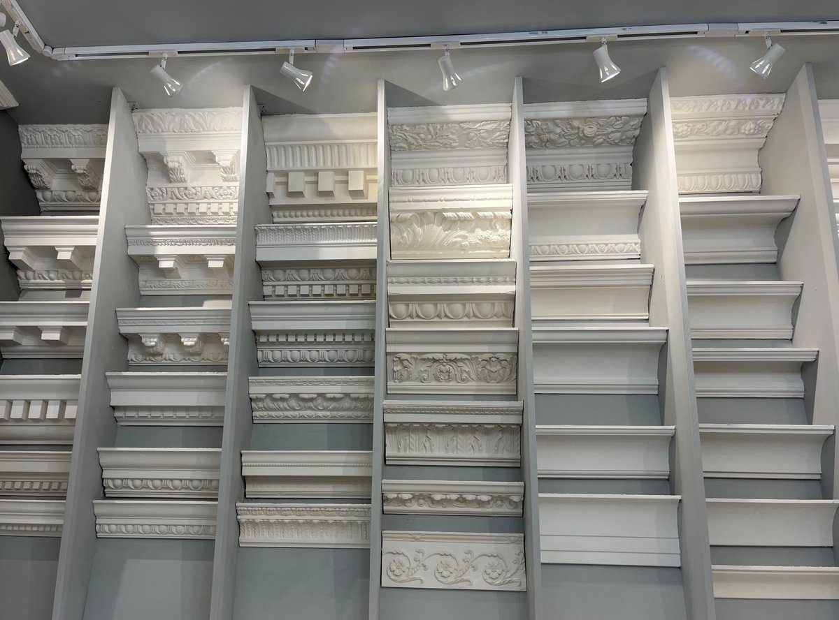 Display of various plaster moldings and cornices.