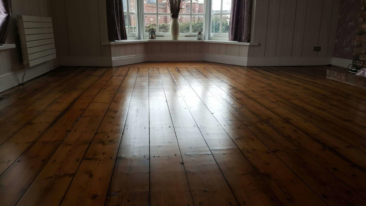 Finished wooden floor, showcasing the restoration work.