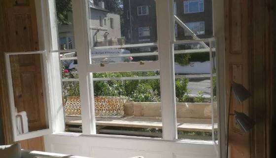 Restored sash window with new glazing and paint.