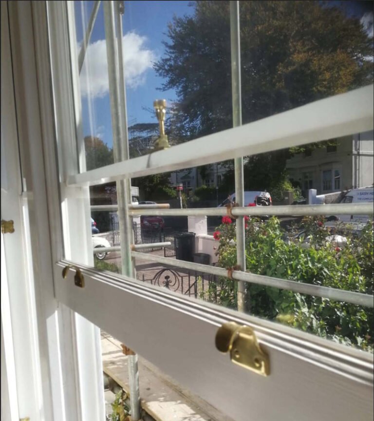 Close-up of a restored sash window with hardware.
