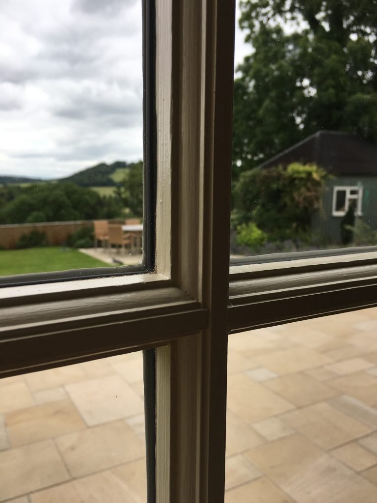 Close-up of a restored window frame, showcasing the craftsmanship and detail.