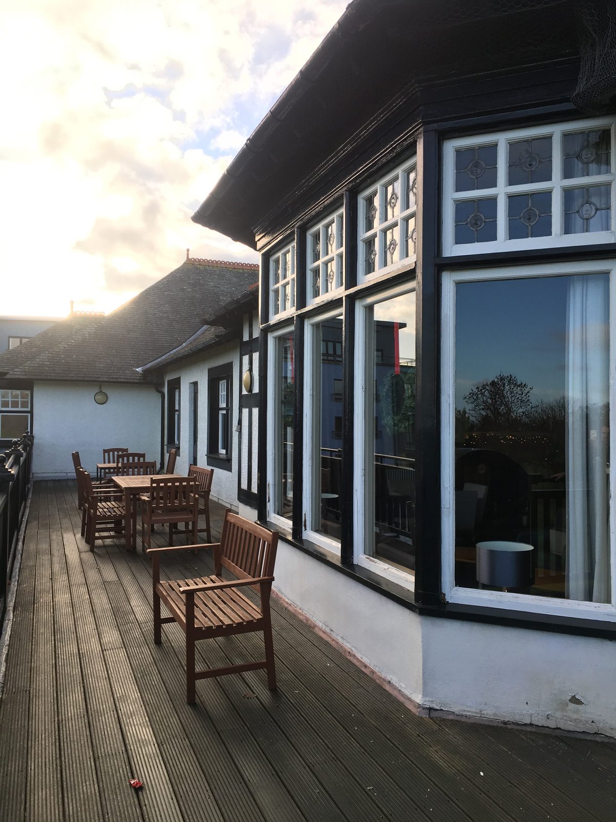 Exterior view of a building with restored windows and a deck area.