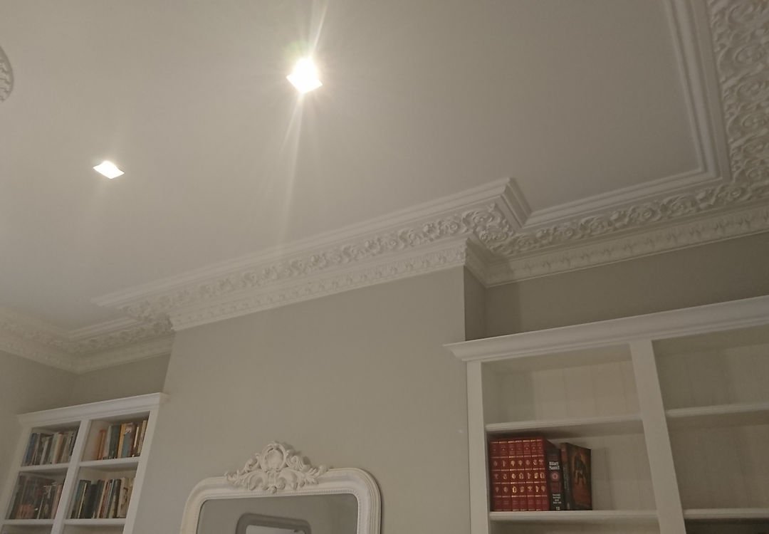 Coving detail with bookshelves, showing a completed room restoration.