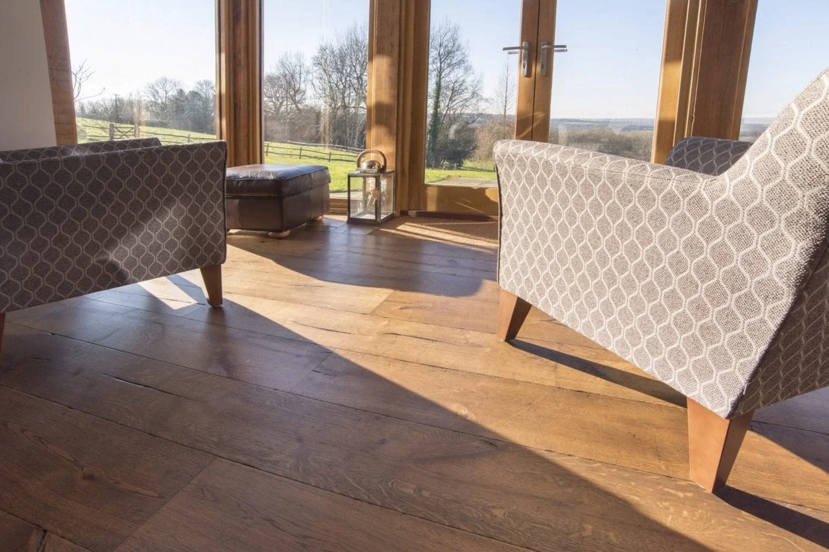 Sunroom with restored wood flooring and furniture.