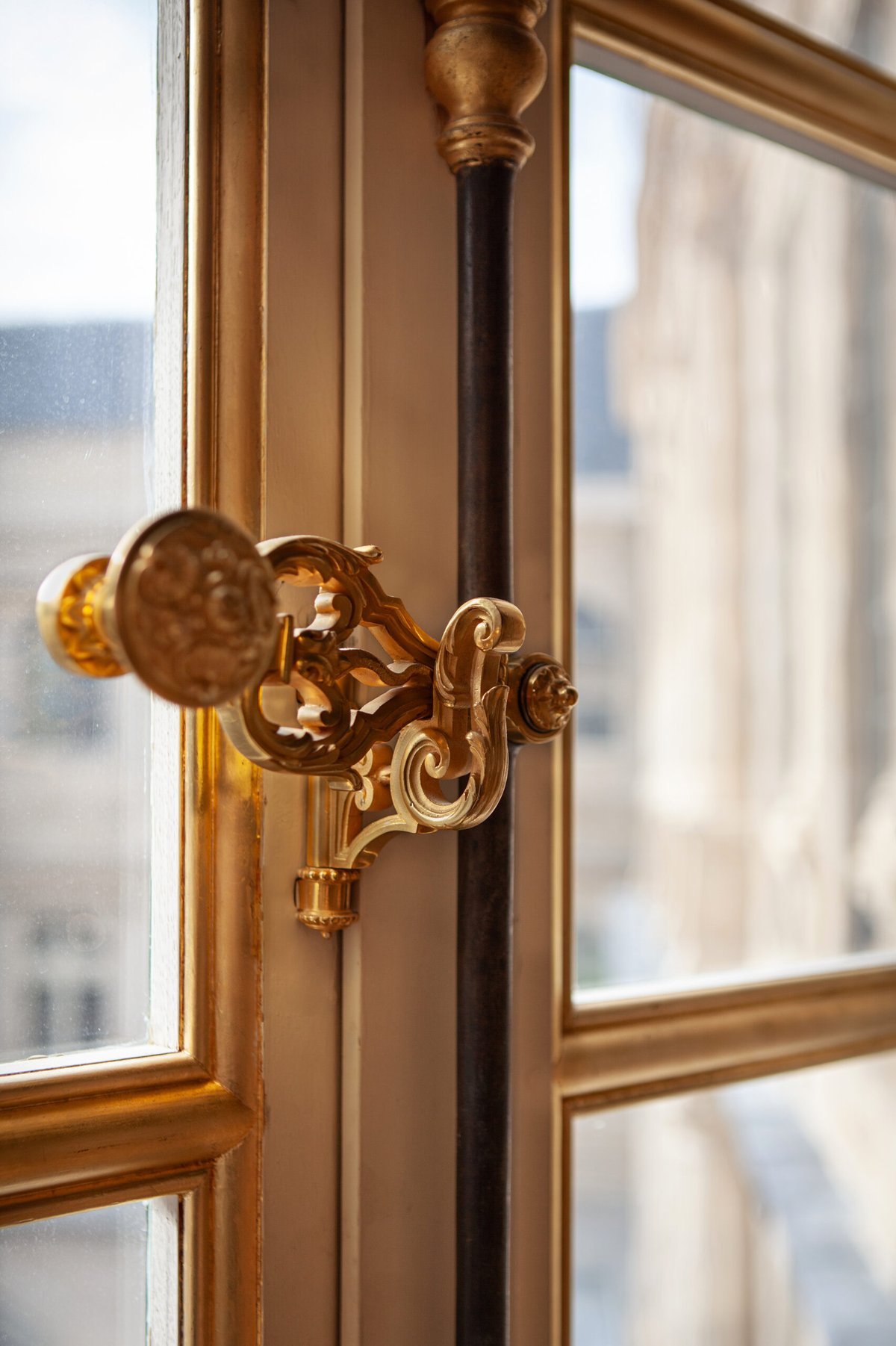 Close-up of ornate window hardware on a timber window.