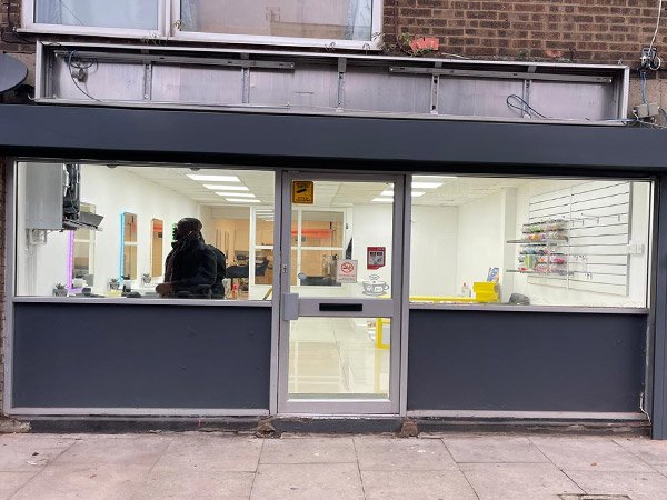 Shopfront with large windows, showcasing their shopfitting capabilities.