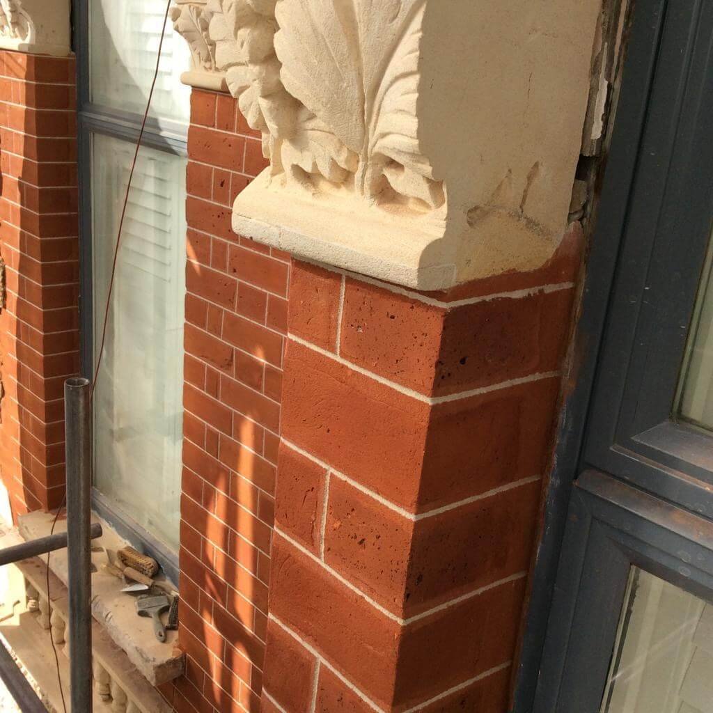 Close-up of restored brickwork with detailed pointing and stonework.