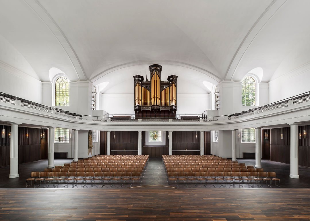 Restored church interior with organ, showcasing architectural restoration work.