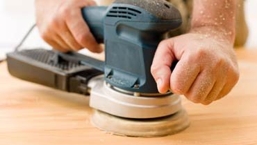 Hand sanding wood floor