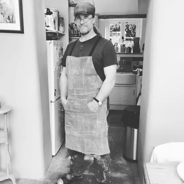 Plasterer in work clothes, possible lime plaster in background.