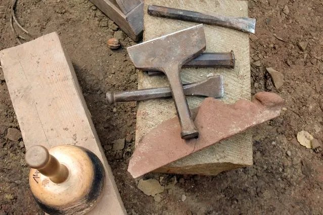 Tools used for plastering or stone work.