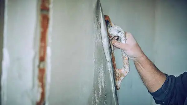 Plastering work in progress, relevant to building restoration.