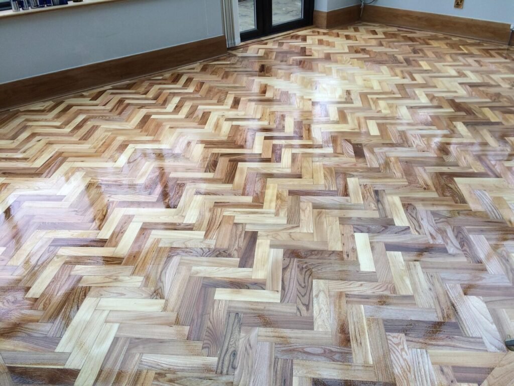Herringbone wood floor after restoration.