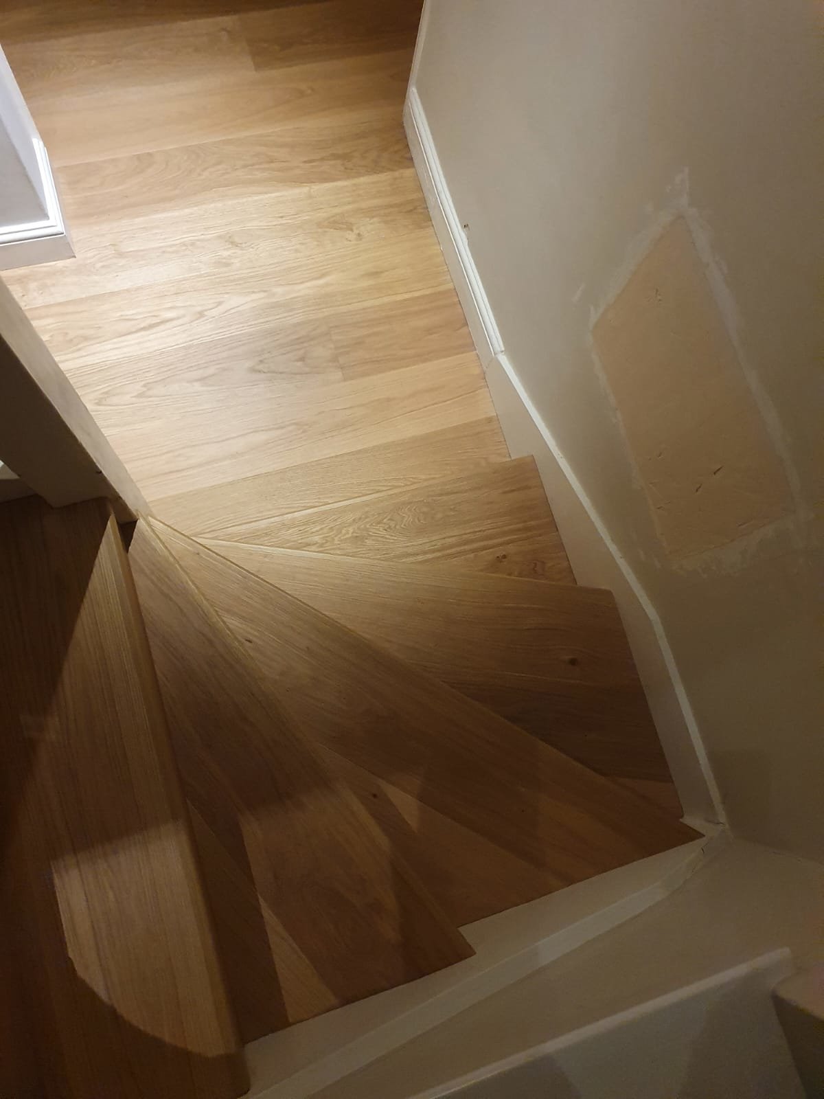 Staircase with sanded and polished wooden steps.